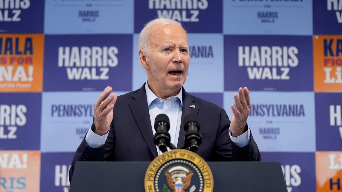 Close-up of Biden at the podium, gesturing with his arms