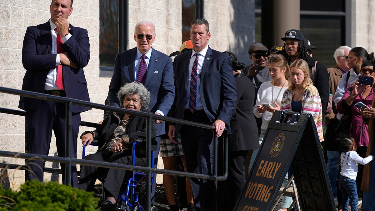 Joe Biden helps a woman in a wheelchair