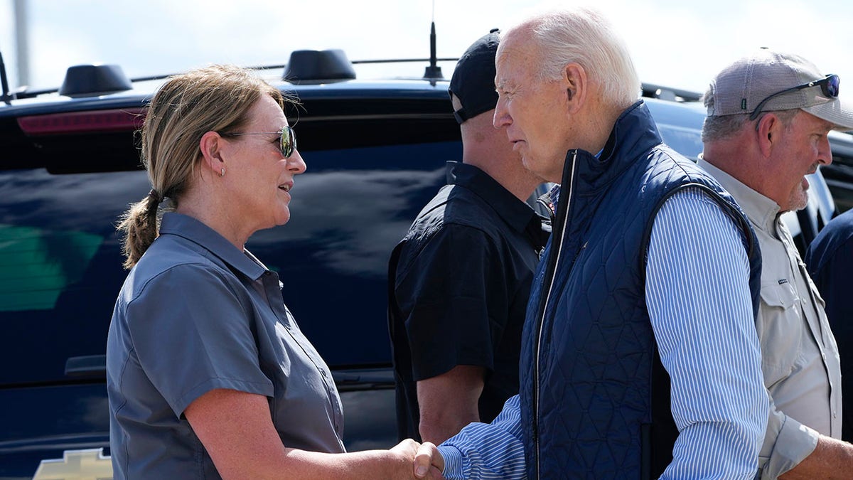 President Joe Biden speaks with FEMA Director Dean Criswell