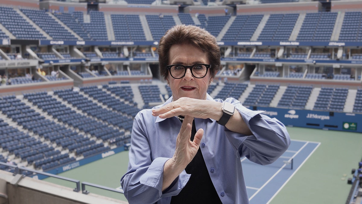 Billie Jean King calls a timeout with his hand