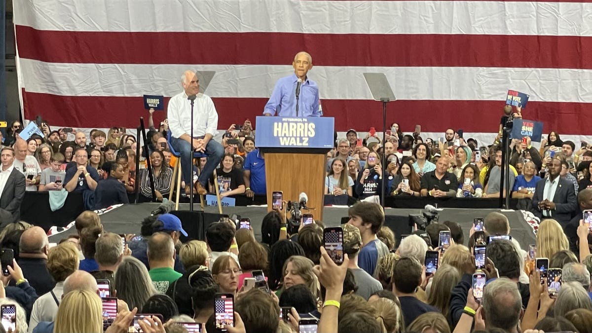 Democratic Sen. Bob Casey of Pennsylvania (left) listens to former President Barack Obama at a rally in Pittsburgh, Pennsylvania on Oct. 10, 2024