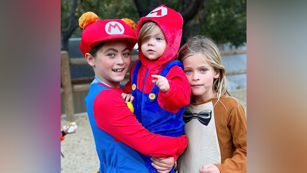 Three of Brian Austin Green's sons dressed in Halloween costumes 