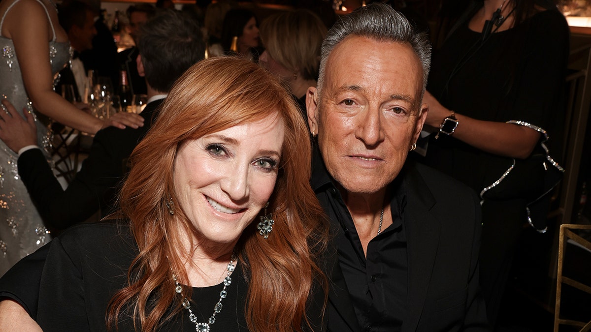 Bruce Springsteen wraps his arm around wife Patti Scialfa.