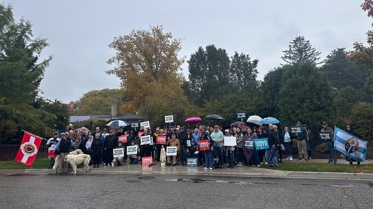 Catholics gather outside the government house. whiter 