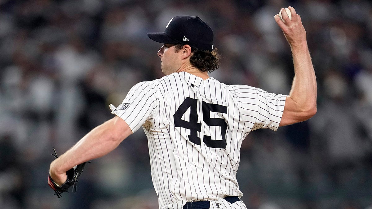 New York Yankees pitcher Gerrit Cole throwing a pitch during a baseball game.