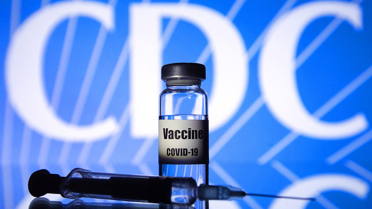 CDC logo behind syringe and vial with label that reads, Vaccine COVID-19