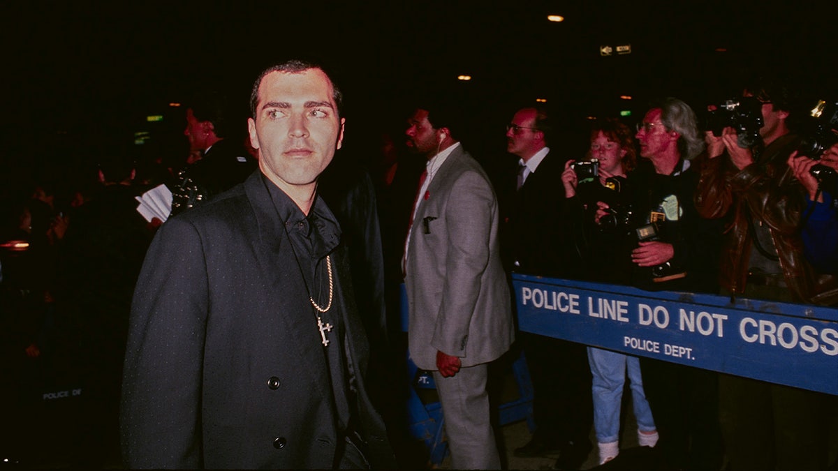 Christopher Ciccone stands on the sidewalk