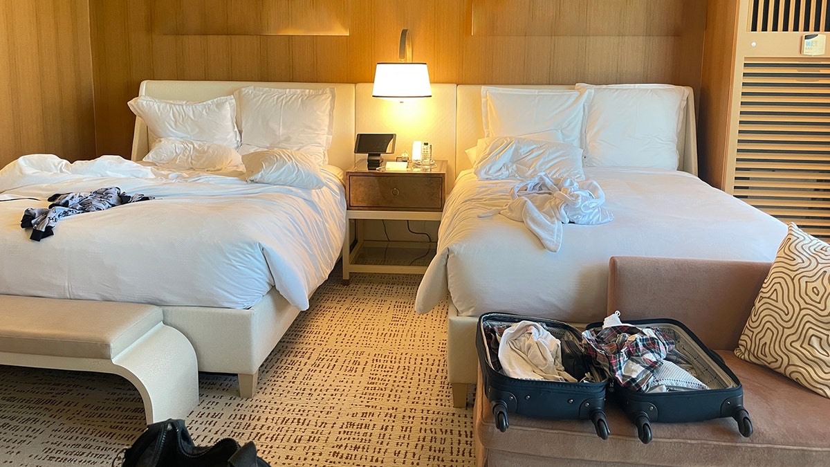 Couples sleeping in two different beds in hotel room