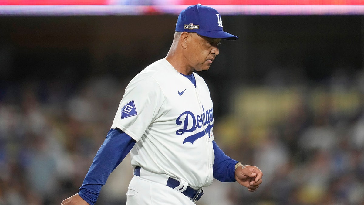 Dave Roberts walks backmost  to the dugout