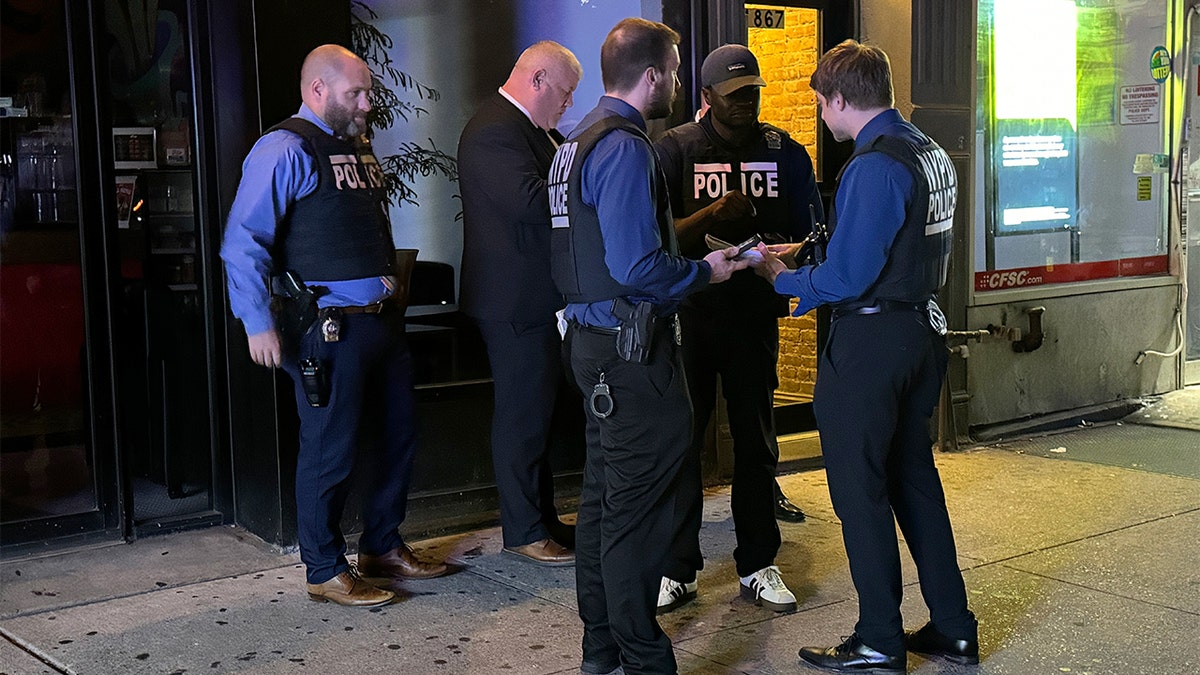 NYPD officers stand near East 96 street and 2nd Avenue