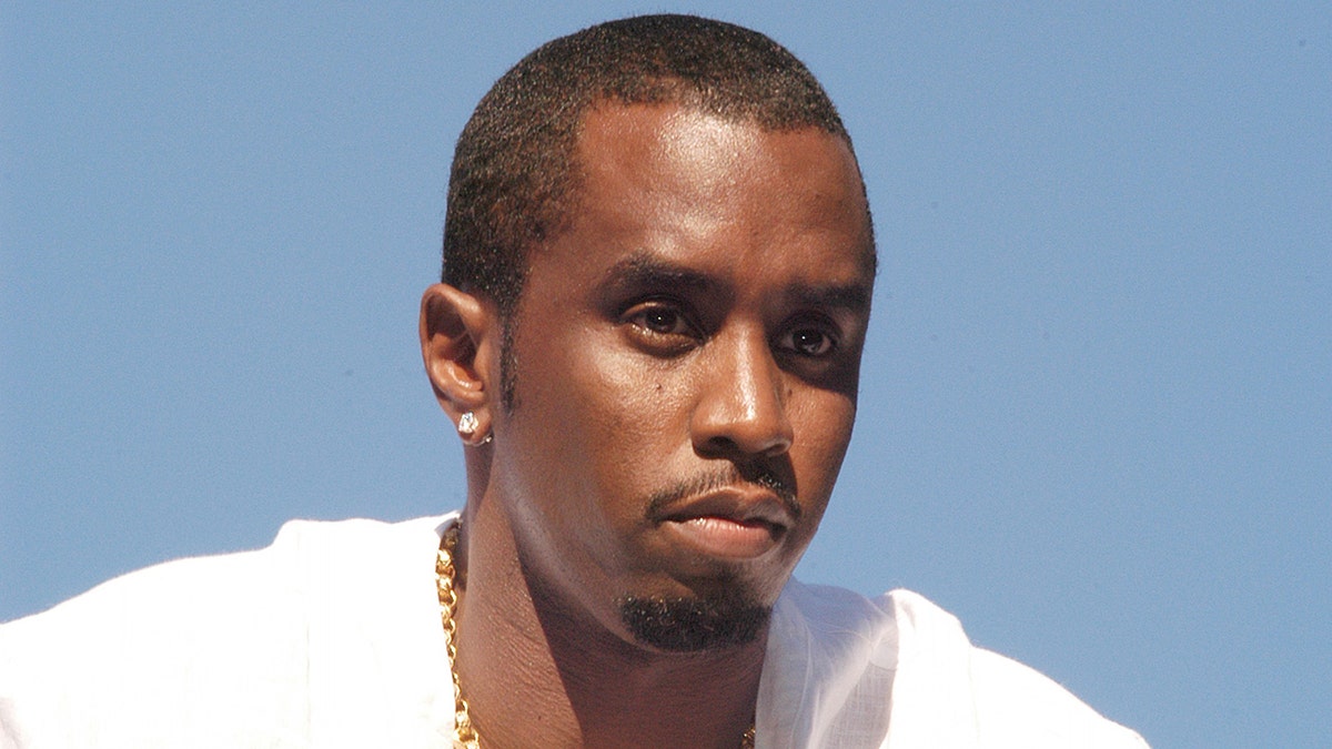 Sean Diddy Combs wears a achromatic  shirt.