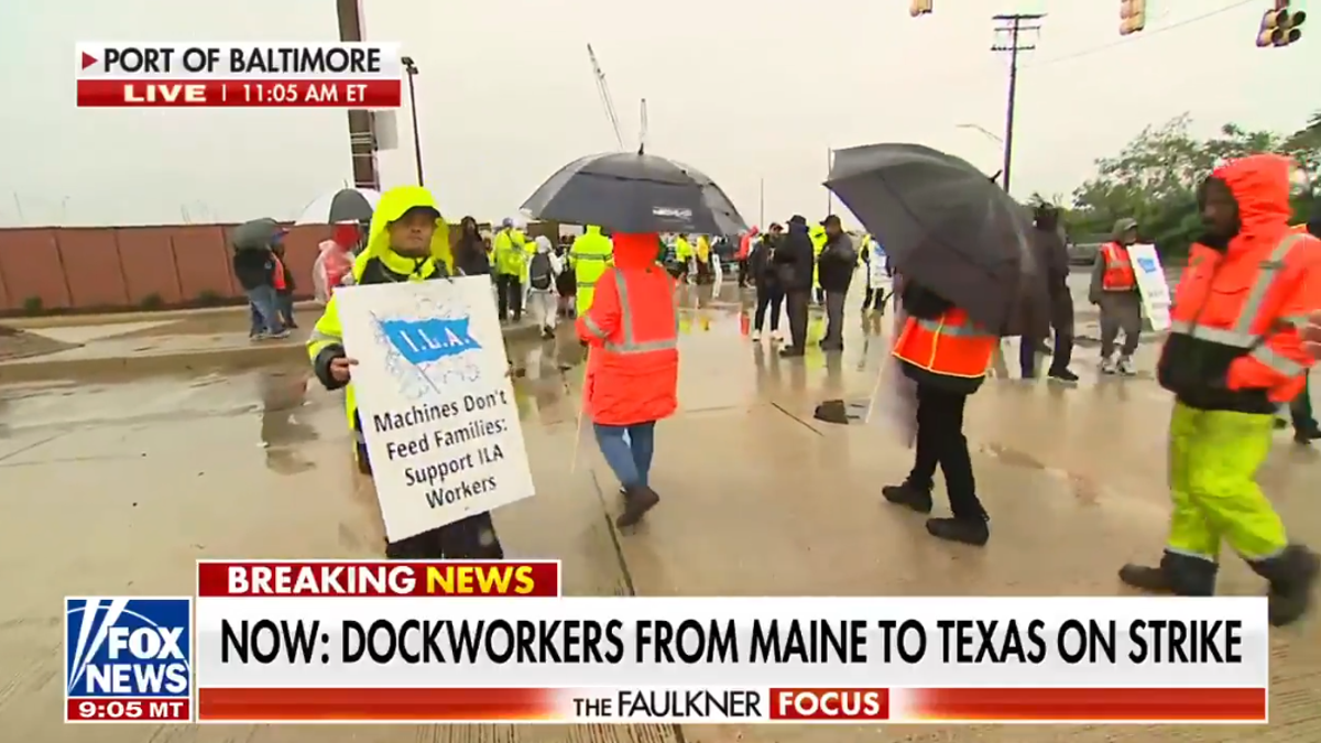 Striking longshoremen locomotion  successful  the rainfall  astatine  the Port of Baltimore arsenic  some  sides jockey for presumption   successful  negotiations.