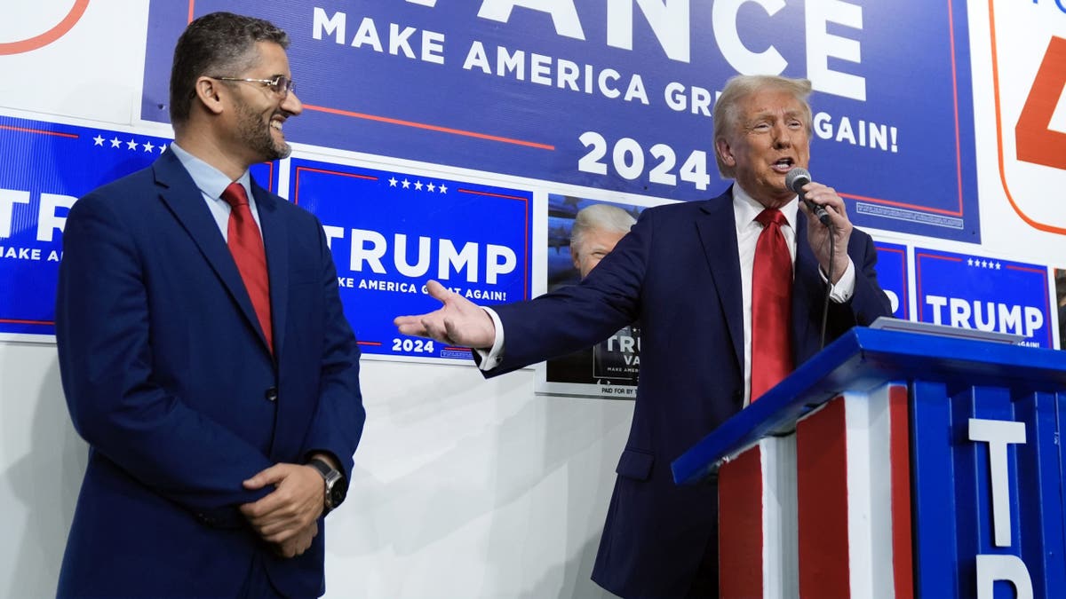 Republican presidential nominee former President Donald Trump speaks as Hamtranck Mayor Amer Ghalib