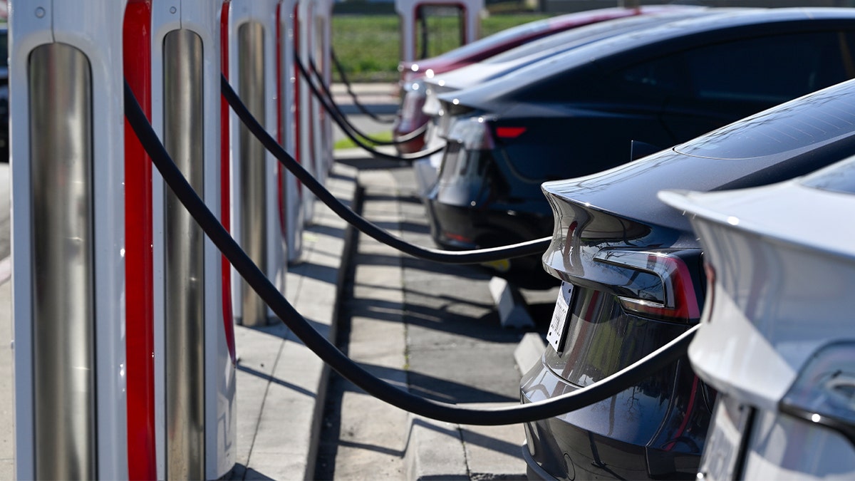 Drivers charge their Teslas in Fountain Valley, Calif., on March 20, 2024.