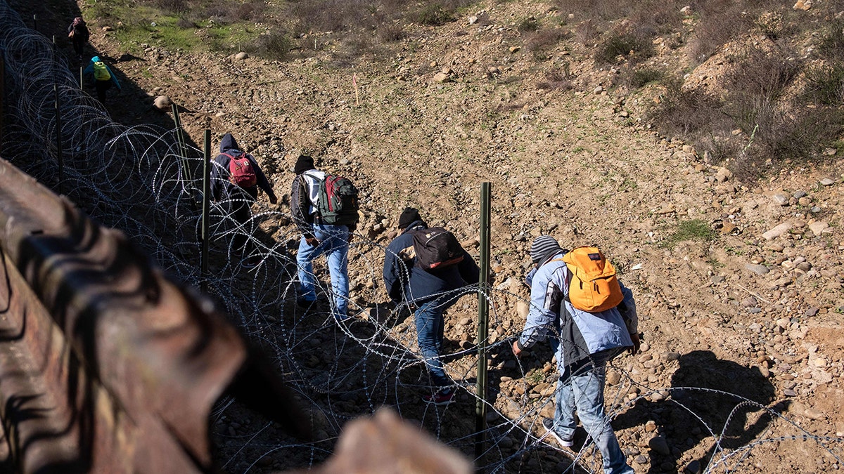 Migrants cross the US border