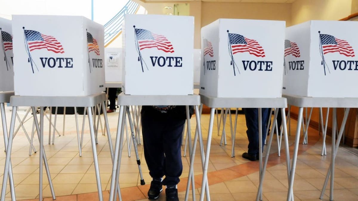 Election officials person respective voting booths disposable for Early Voting astatine nan Broomfield City and Coutny Building connected Tuesday. October 21, 2008 Enterprise unit photo/David R. Jennings(Photo by David Jennings/Digital First Media/Boulder Daily Camera via Getty Images)