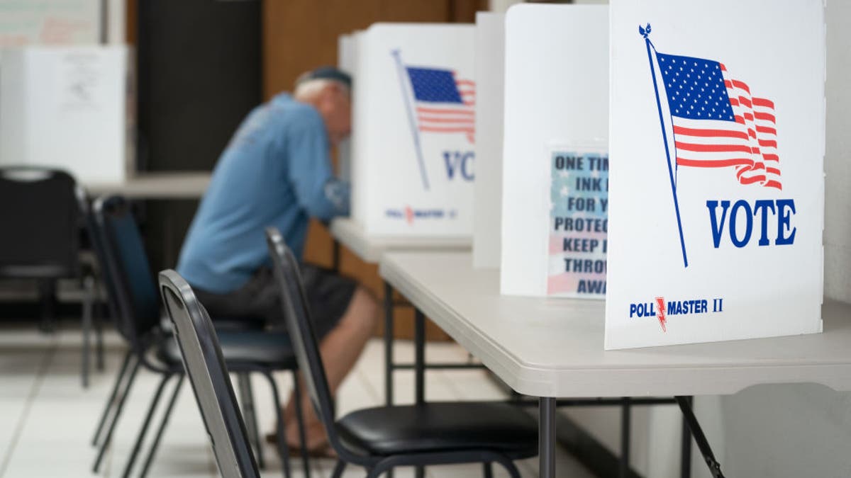 A man fills out a ballot at a voting booth in Mt. Gilead, North Carolina, on May 17, 2022.