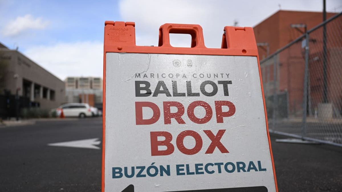 A sign directs Arizona voters to an early voting ballot box outside the Maricopa County Tabulation and Election Center in Phoenix.