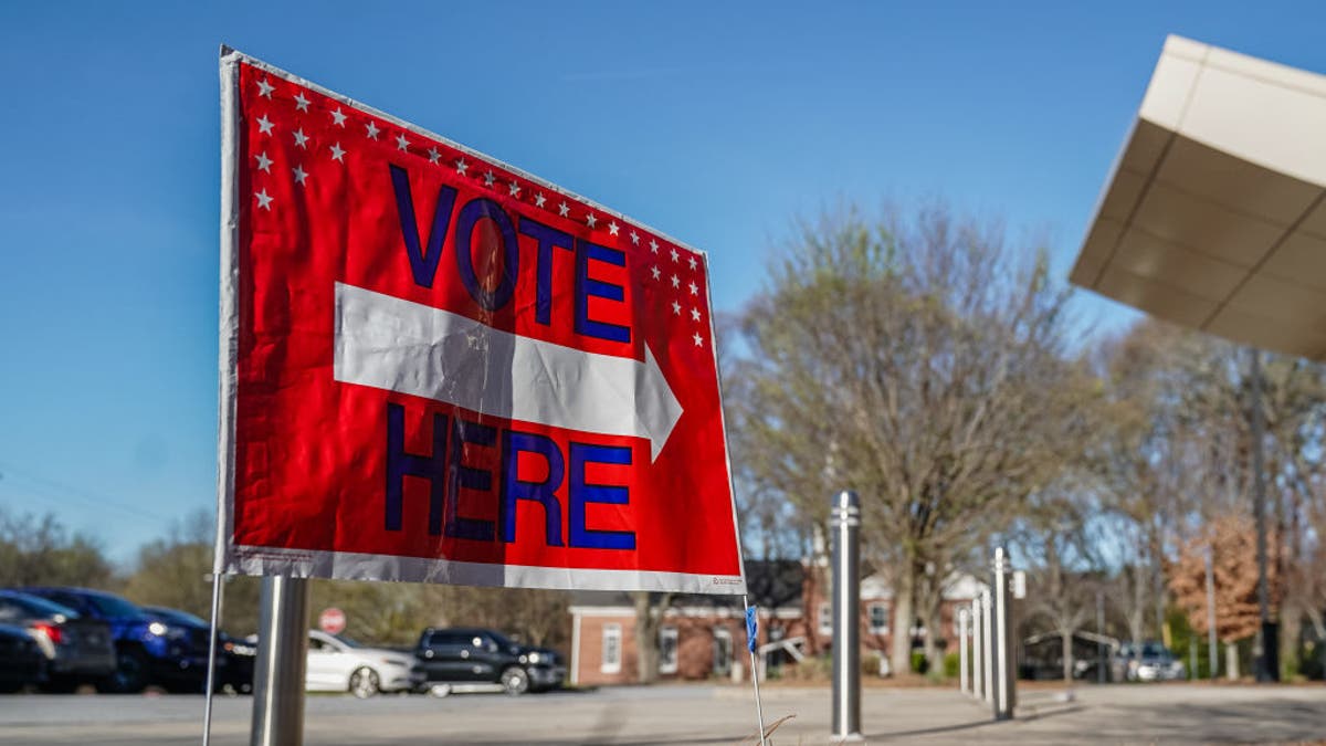 A "Vote Here" signs directs voters to a precinct during the presidential primary elections in Atlanta on March 12, 2024.