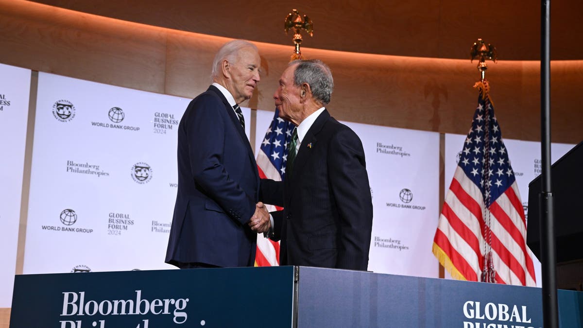 President Biden, left, and former New York City Mayor Michael R. Bloomberg, founder of Bloomberg Philanthropies, shake hands on stage at the Bloomberg Global Business Forum on Sept. 24, 2024 in New York City.