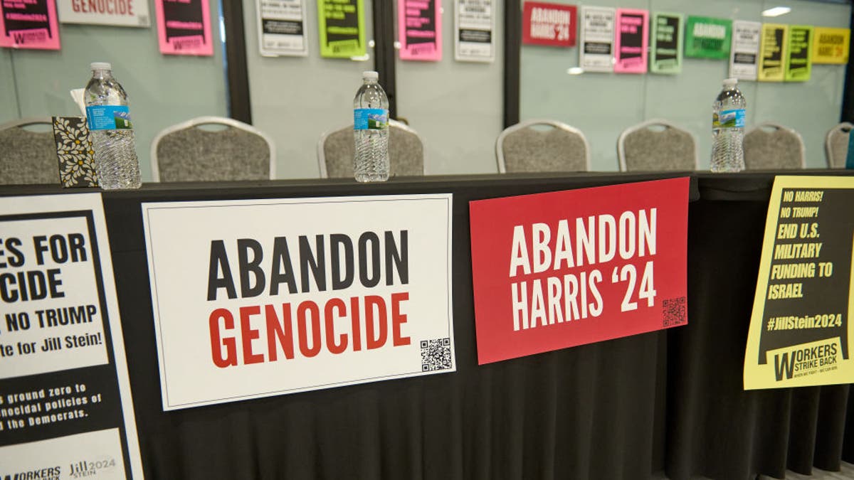 Abandon Genocide, Abandon Harris signs connected  table