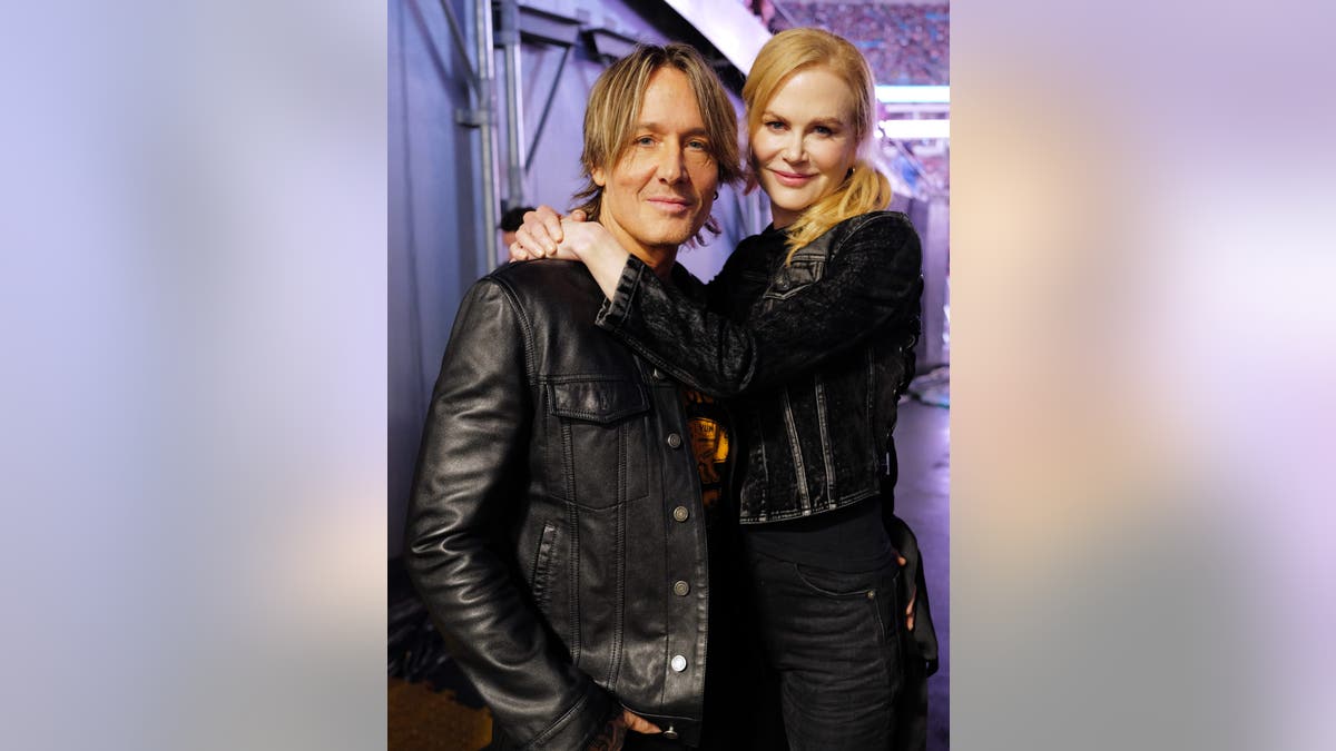 nicole kidman and keith municipality  hugging backstage astatine  concert