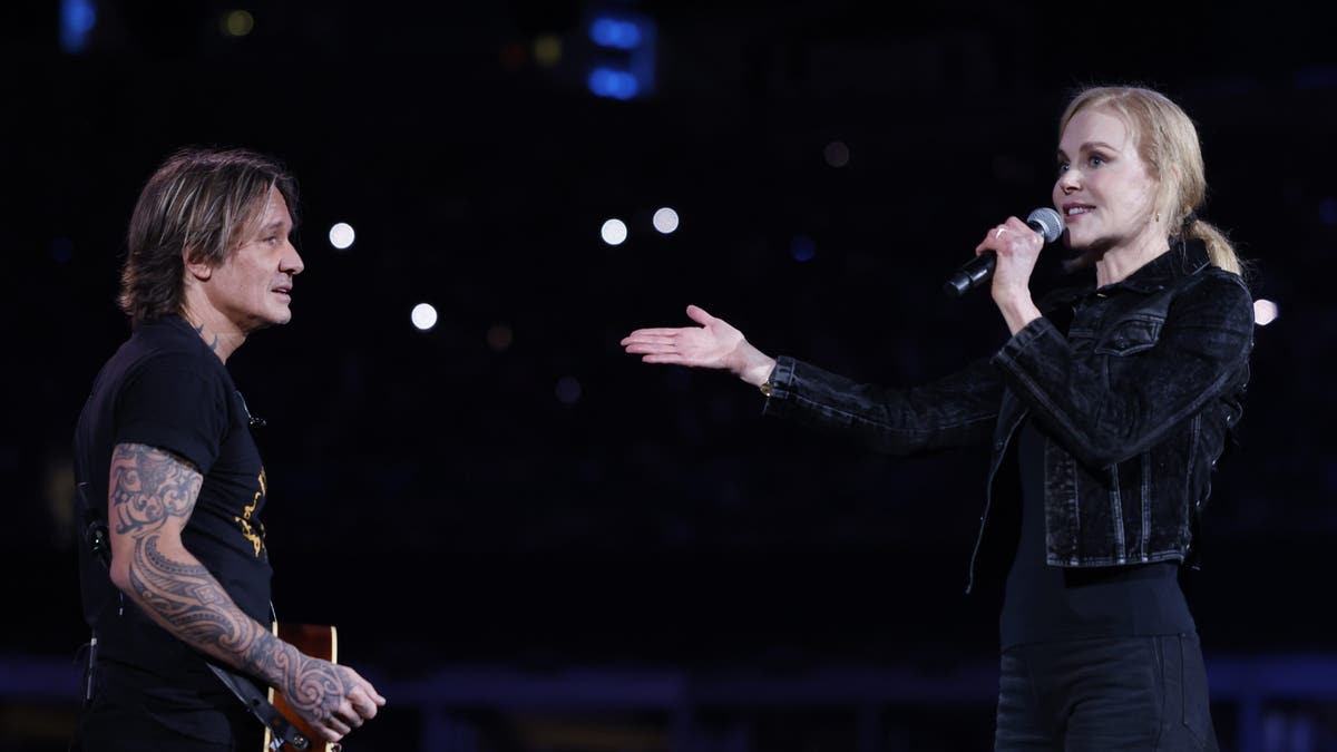 Nicole Kidman and Keith Urban on stage at a concert