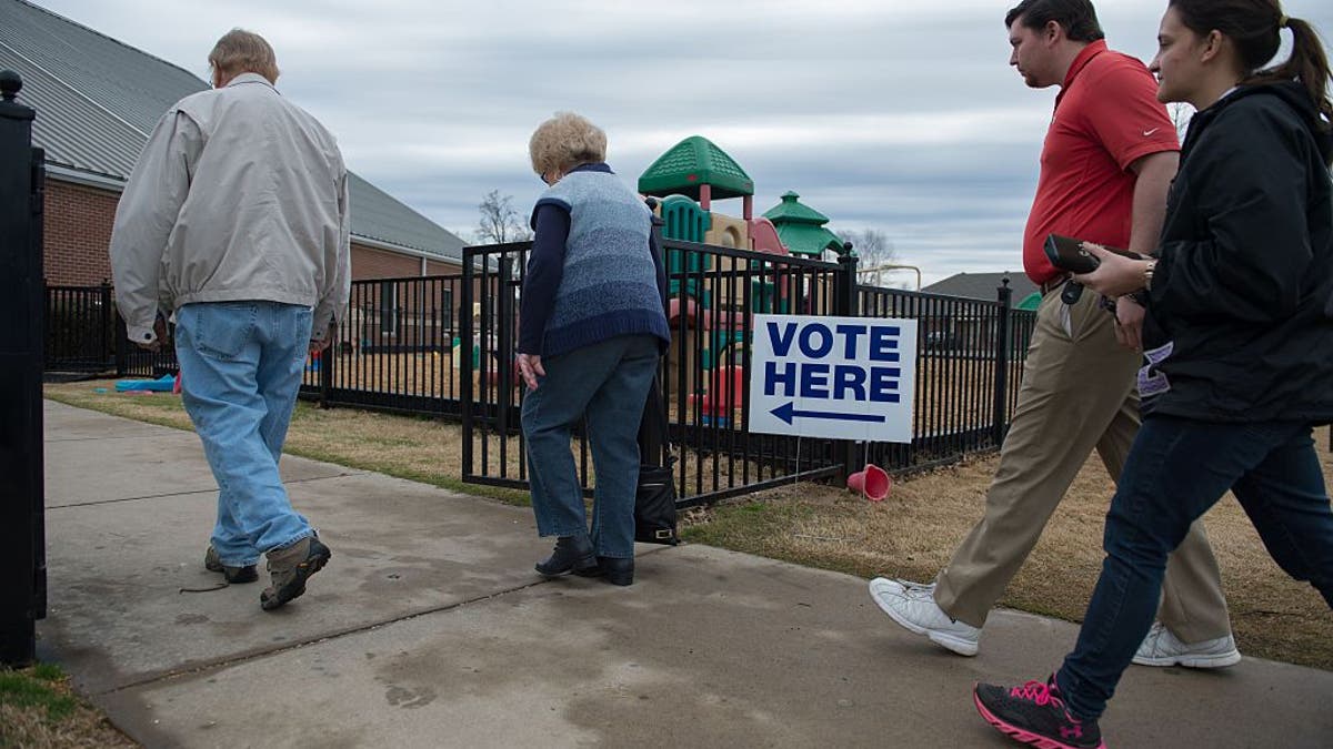 Voters arrive to cast their ballot at Grace United Methodist Church in Conway, Arkansas on March 1, 2016.