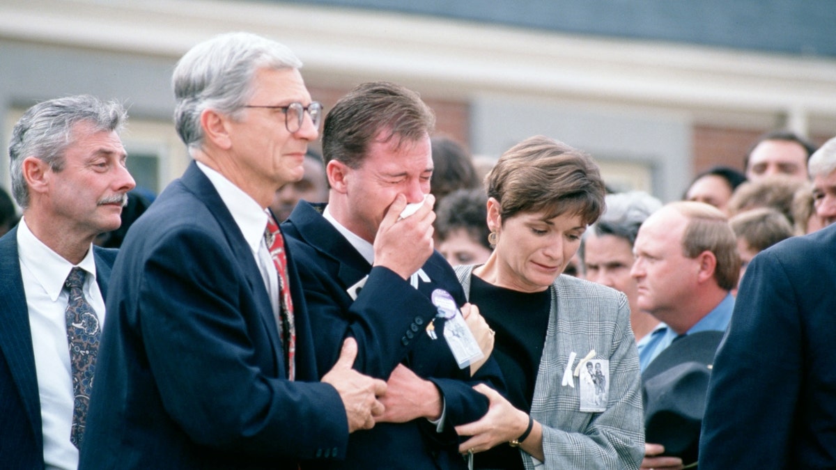 David Smith, the boys' father, leaves the church after the funeral service for the two boys.