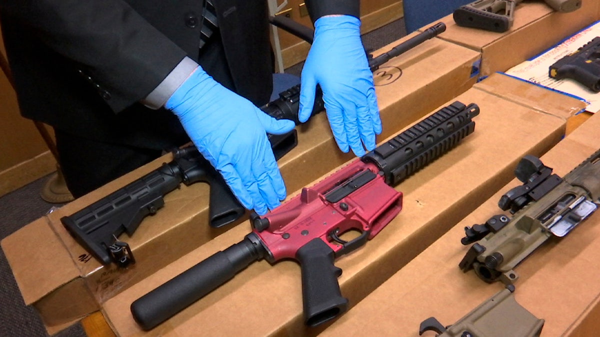 Ghost guns are displayed at a police station.