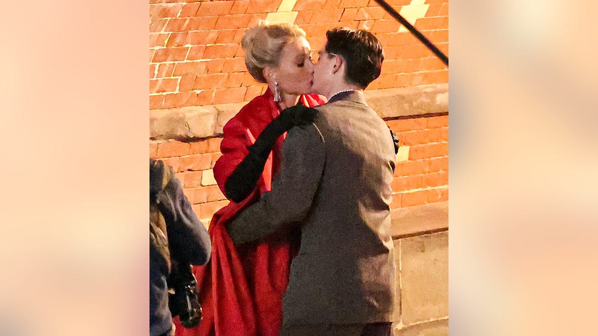 Gwyneth Paltrow in a red dress kisses Timothée Chalamet on the set of their film 