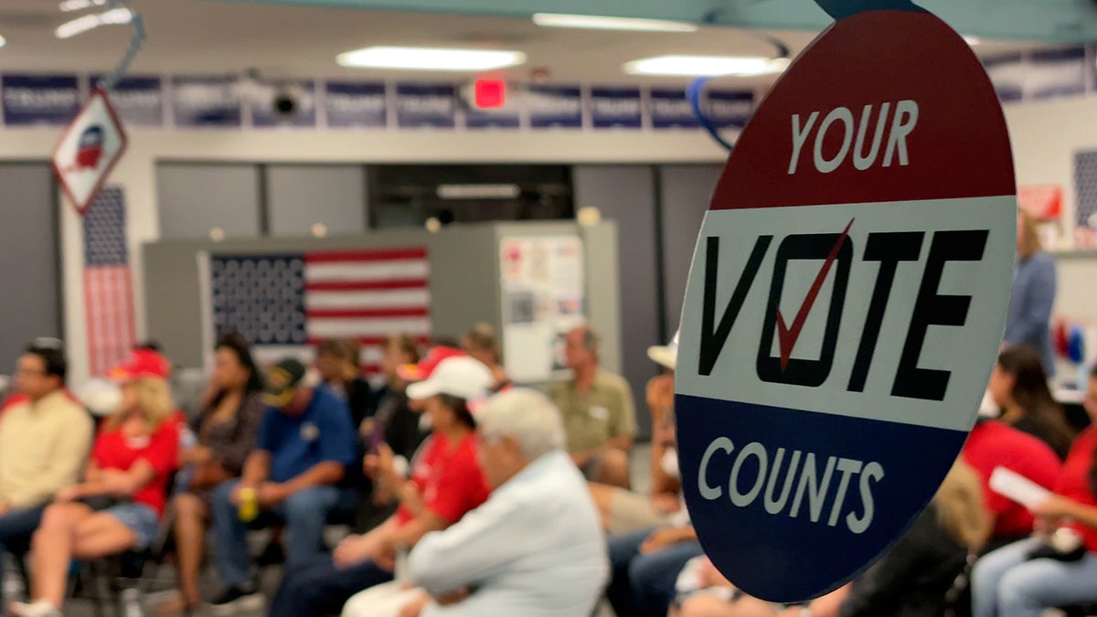 Decorations saying "your ballot  counts" bent  from structure   astatine  Hispanic GOP voters event