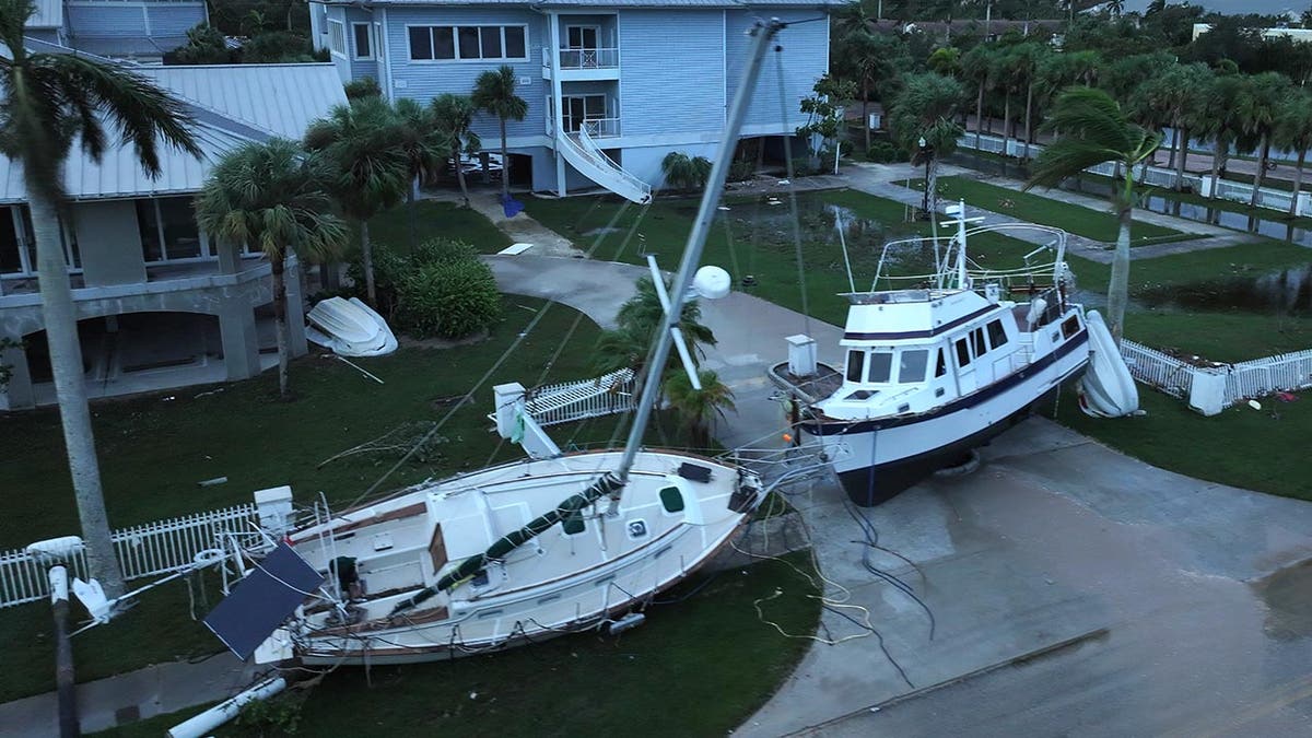 In this aerial view, boats rest in a yard after they were washed ashore when Hurricane Milton passed through the area
