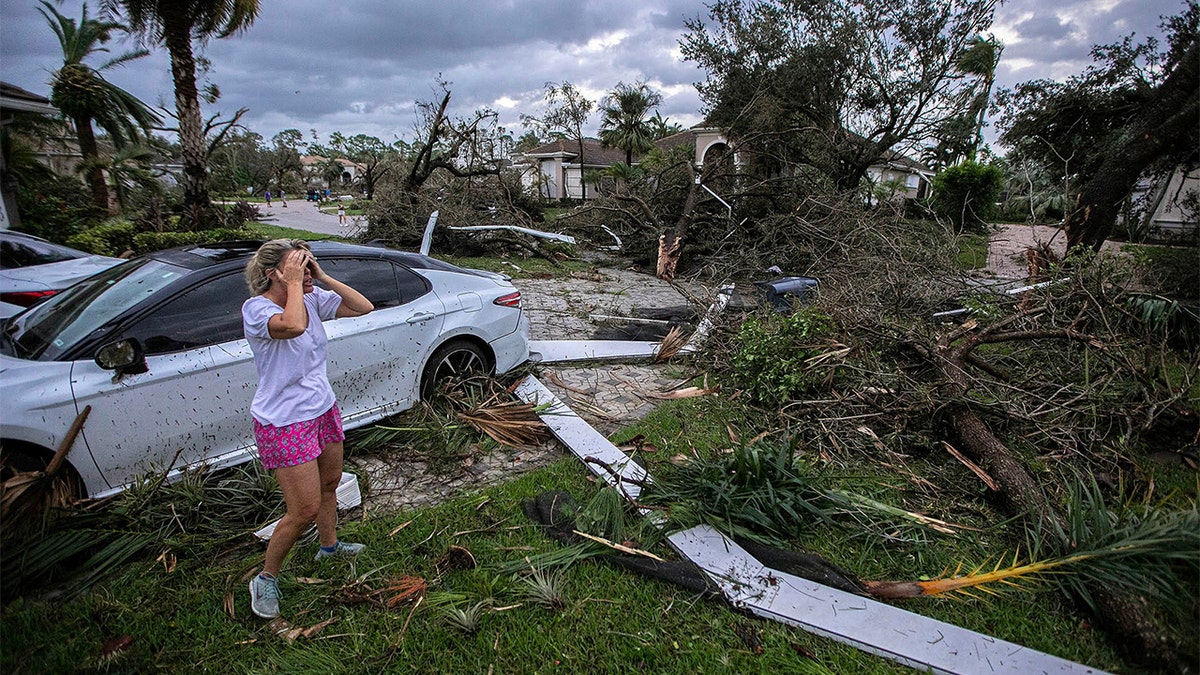 A woman reacts to damage.