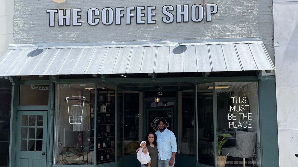 Man, woman, and kid  successful  beforehand   of The Coffee Shop, a cafe successful  Alabama.