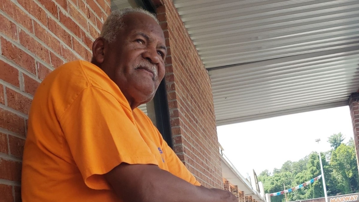 Kenneth Turner sitting extracurricular  his antique store