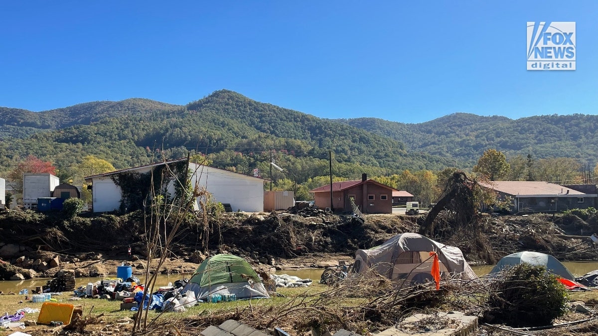 Tents connected  Dara Cody's erstwhile  spot   on  the Swannanoa River