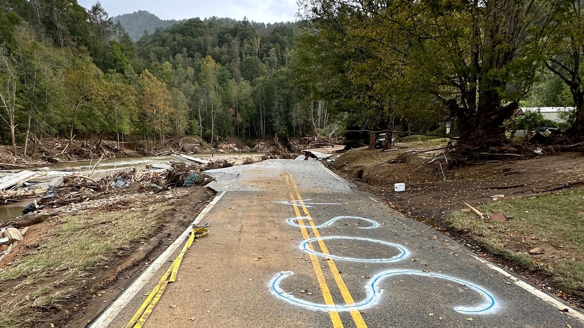 'SOS' spray-painted connected pavement