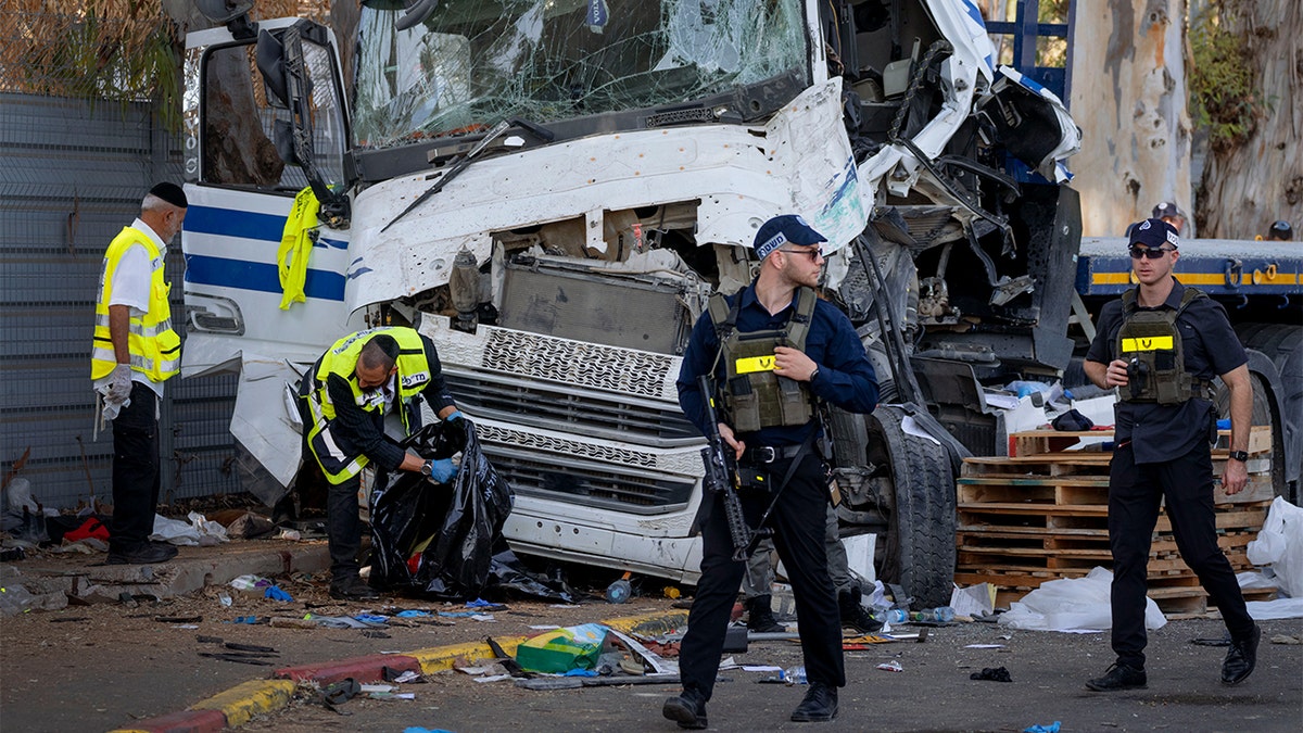 Israeli first responders at the scene of an attack where a truck driver rammed into a bus stop