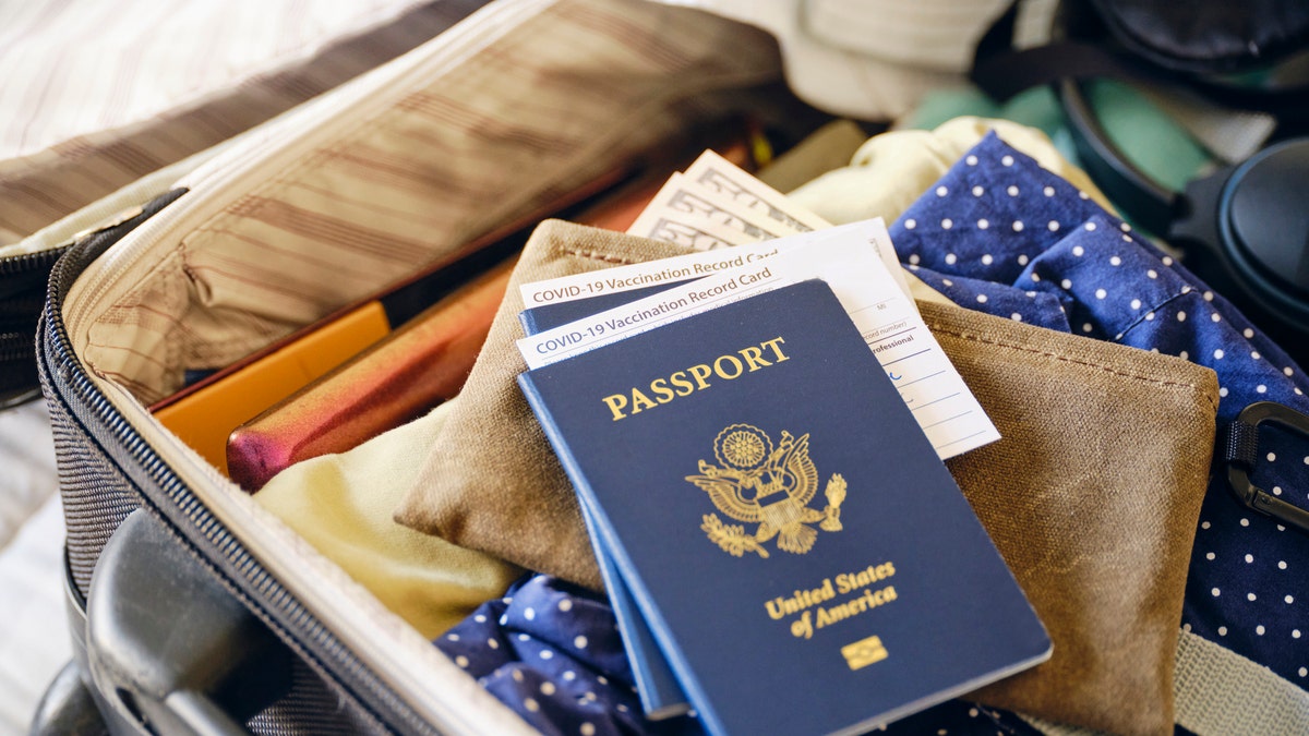 Passport, suitcase, and vaccination card