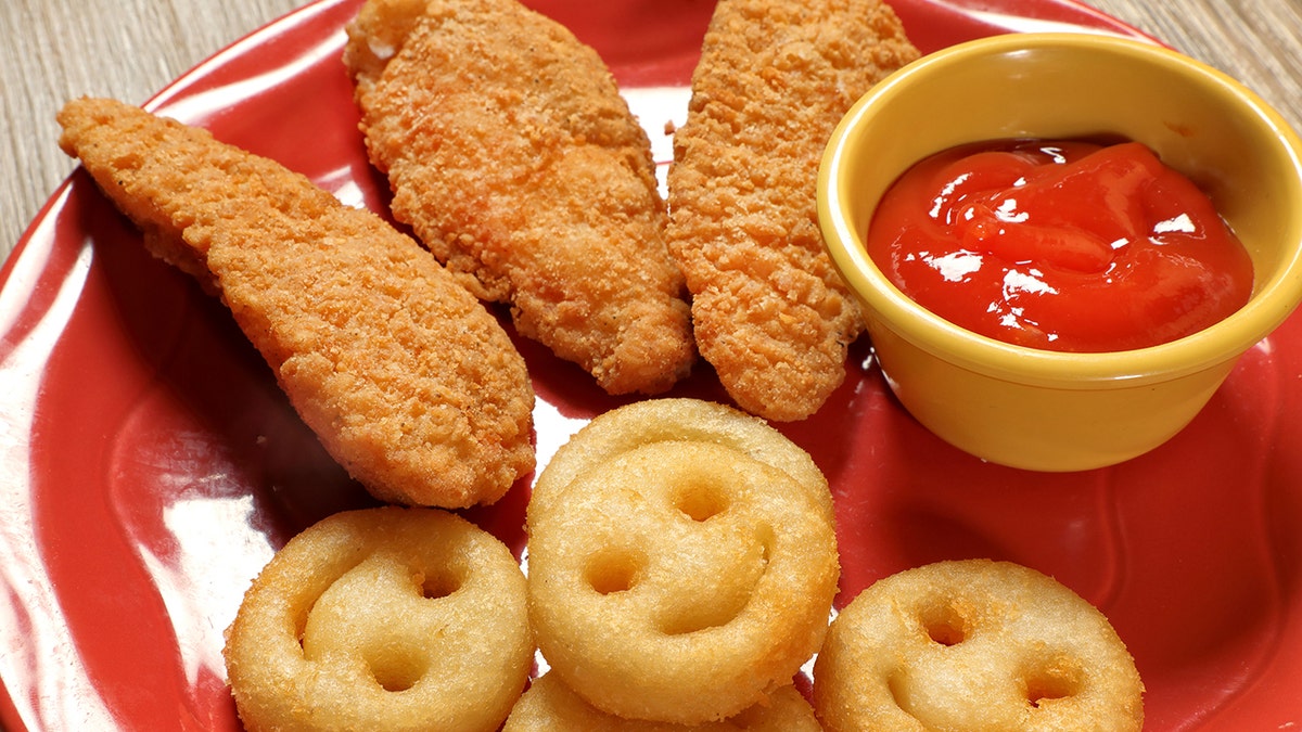 french fries and chickenhearted  fingers with ketchup