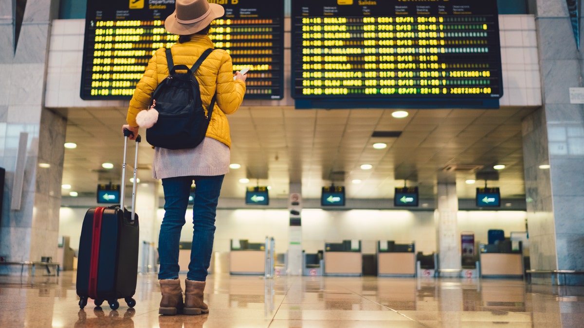 traveler at airport passport news