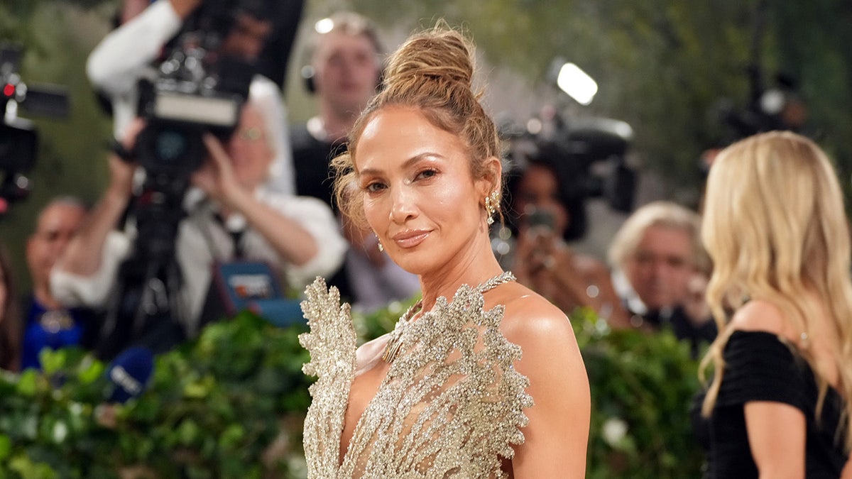 Close up   of Jennifer Lopez connected  Met Gala reddish  carpet