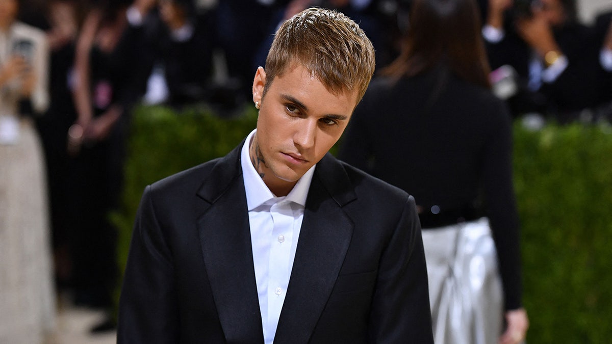 Justin Bieber tilts his head while posing at the Met Gala