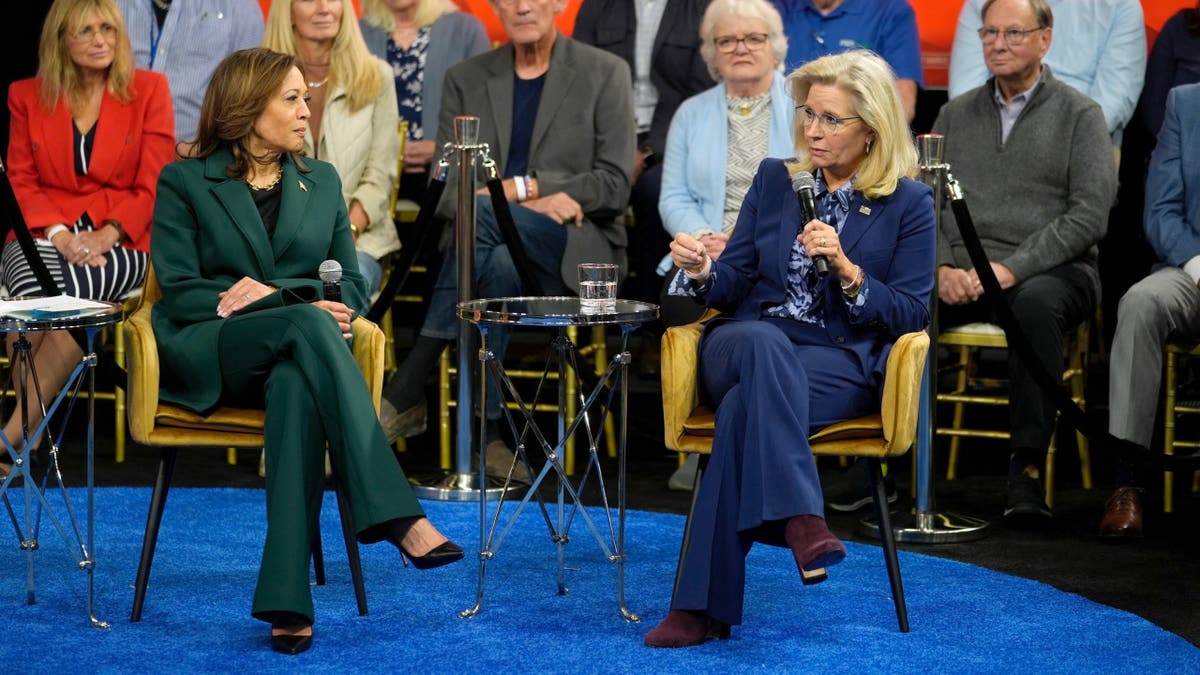 Democratic presidential candidate Vice President Kamala Harris listens as former Republican Rep. Liz Cheney speaks during a town hall at People's Light in Malvern, Pennsylvania, Monday, Oct. 21, 2024.