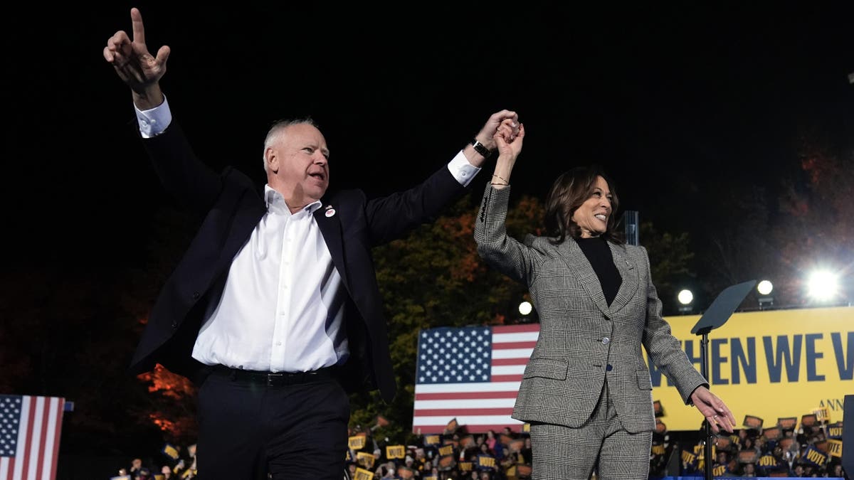 Democratic presidential candidate Vice President Kamala Harris and her running mate, Minnesota Governor Tim Walz, leave after speaking during a campaign event at Burns Park in Ann Arbor, Michigan, on Monday, October 28, 2024.