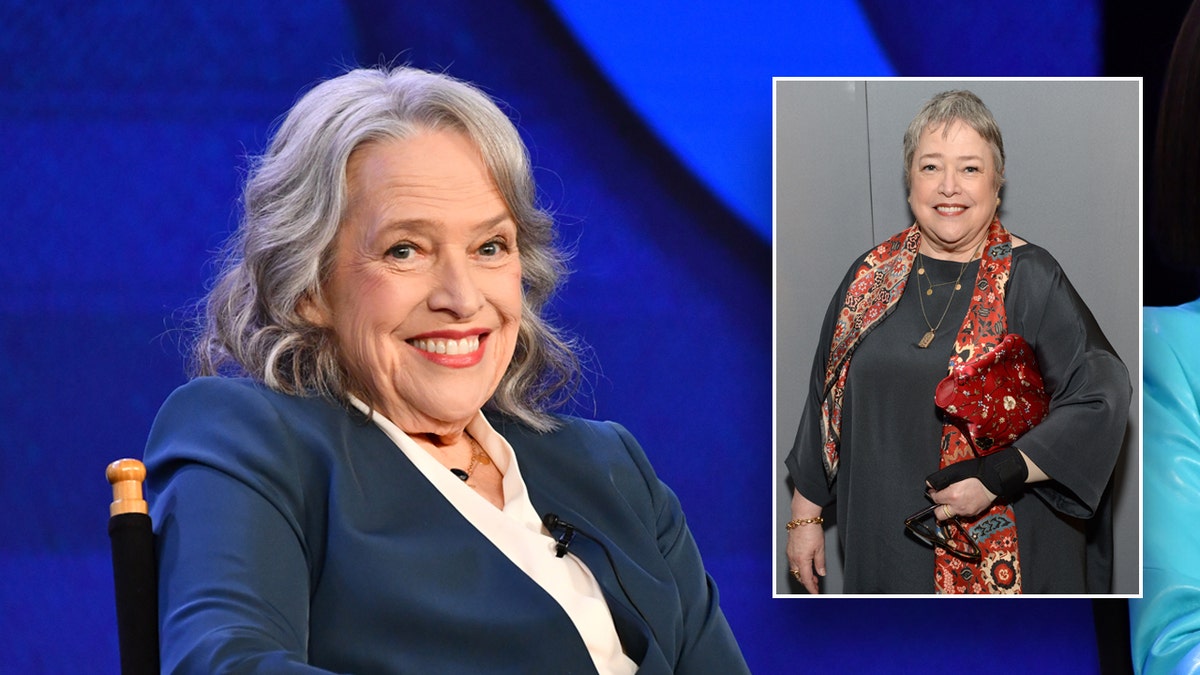 Kathy Bates smiles successful  a bluish  suit, walks reddish  carpet.