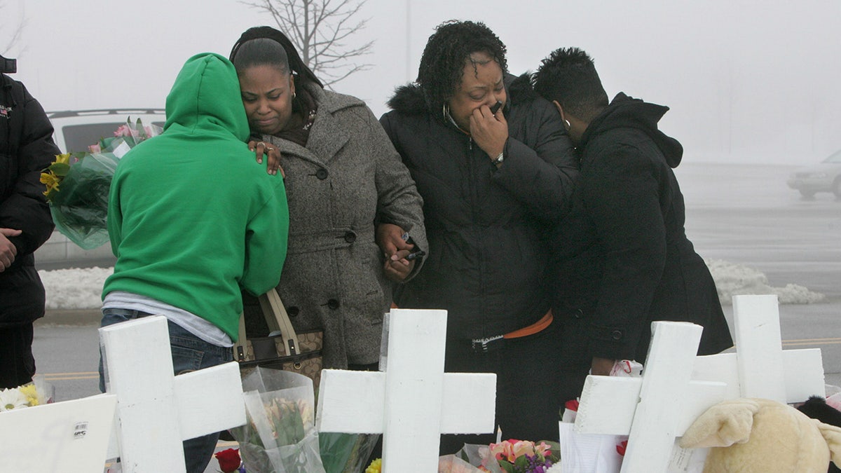 Mourners gather near the Lane Bryant store in the Brookside Market shopping center in Tinley Park on Monday, February 4, 2008