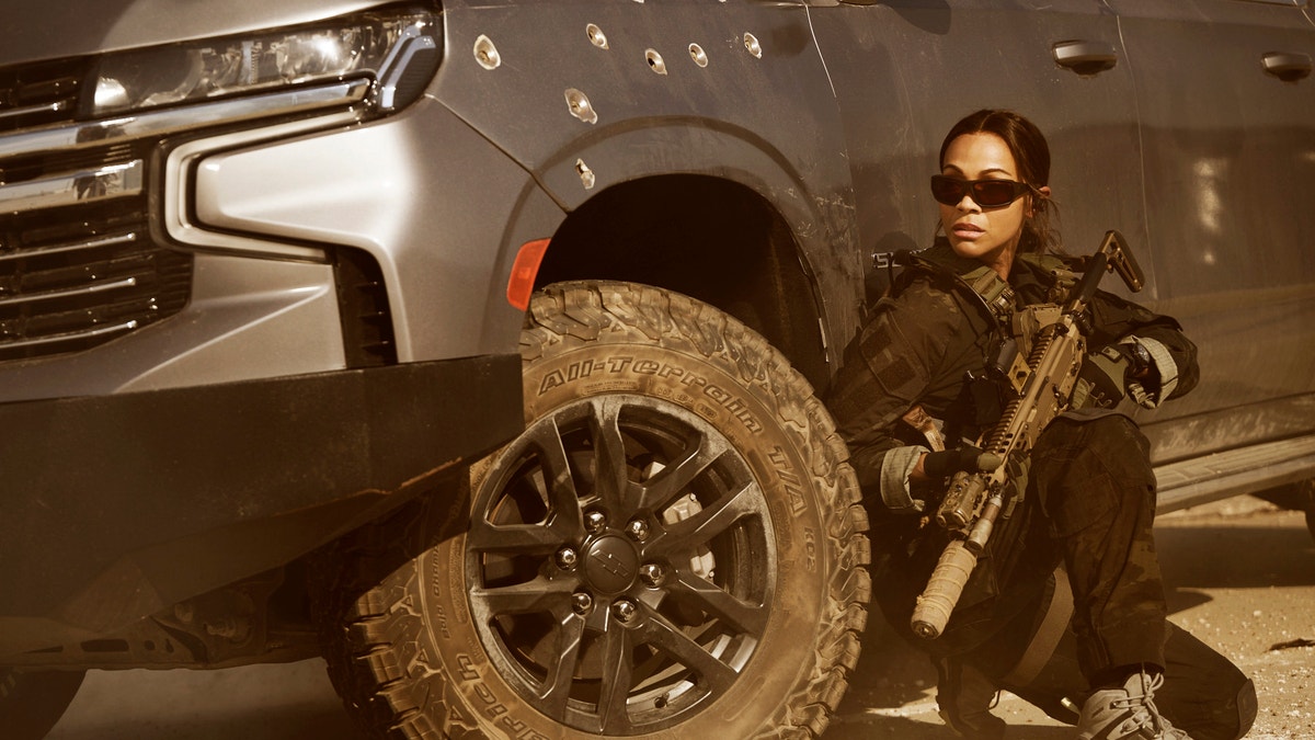 Zoe Saldana in Lioness holding a gun