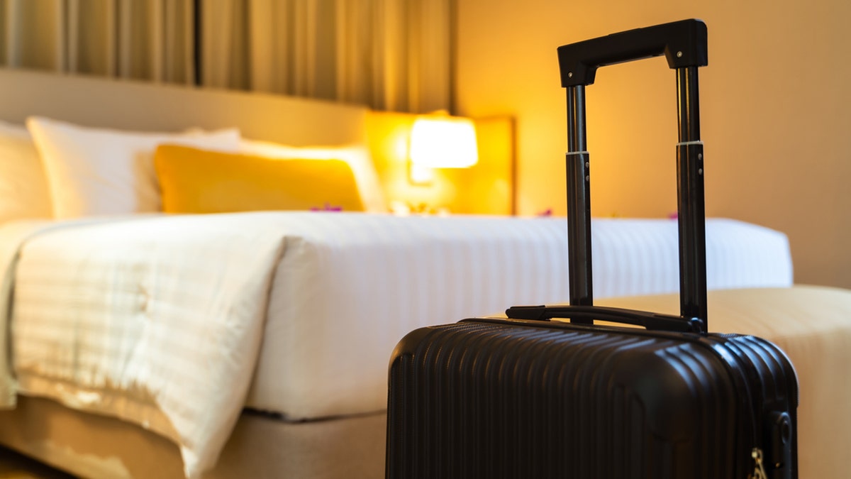 Reddit drama goes viral as woman slams hotel shower designs HOTEL ROOM with suitcase in foreground